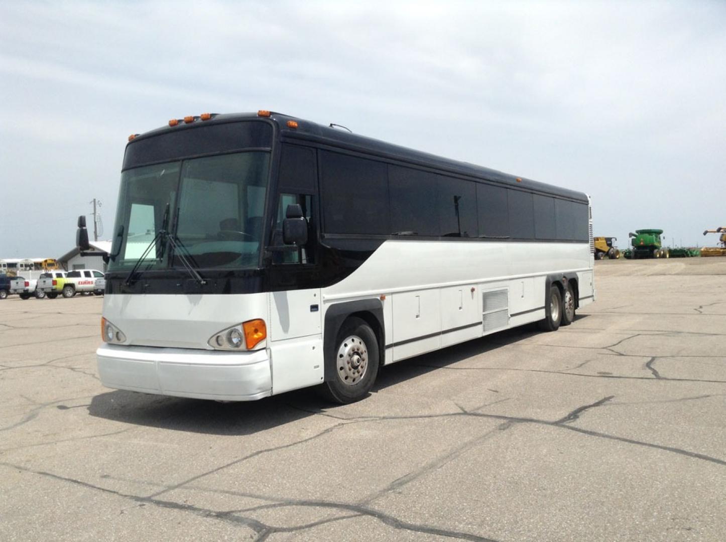 2000 White MCI 102-DL3 with an Detroit Diesel Series 60 engine, Allison transmission, 0.000000, 0.000000 - 2000 MCI 102-DL3 - Series 60 Diesel Engine - Allison Auto Trans. - 45' - 55 Passengers - Flat Screens and DVD - Aluminum Wheels - Enclosed parcel racks – Restroom - New Paint - New Interior - Photo#1