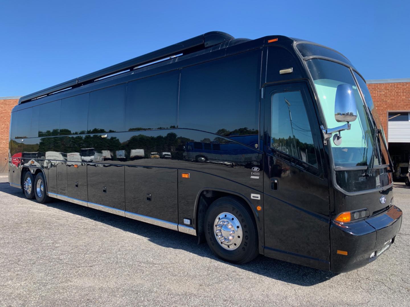 2006 Black MCI E4500 with an Caterpillar D13 Diesel engine, Allison transmission, 0.000000, 0.000000 - 2006 MCI – Caterpillar D13 Diesel, Allison Trans, 45’ Long, Front Lounge, Kitchen, Bath w/Shower, Rear Lounge (could convert to Bedroom), Closet Space, 2 Electric Awnings, 2 Roof A/C w/Heat Strips, 20KW EPS Diesel Generators, Aluminum Wheels, Interior by Amadas, One Owner, Garage Kept. - Photo#1